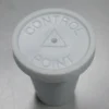 A white control point button sitting on top of a table.
