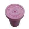 A pink bottle cap with the words " boundary marker ".