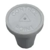 A white control point button sitting on top of a table.