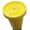 A yellow gas line cap sitting on top of a pipe.